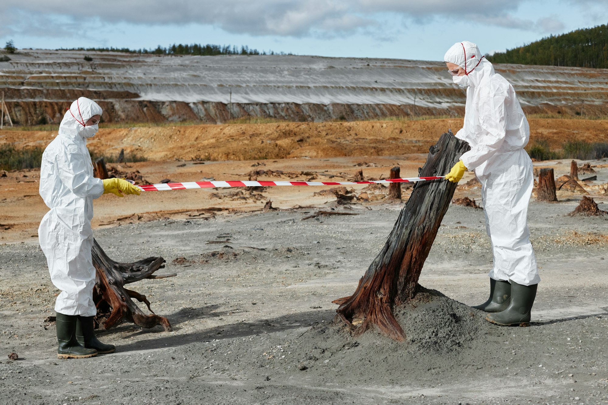 Environmental workers using warning tape